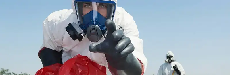 sewage clean up technician wearing protective gear handling biohazard materials in Spokane, WA